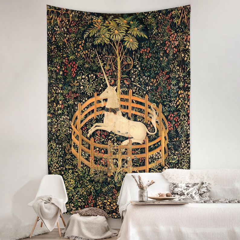 May include: A tapestry featuring a white unicorn trapped in a circular wooden fence. The unicorn is surrounded by a lush green forest with colorful flowers and leaves. The tapestry is a reproduction of the famous Unicorn tapestries.