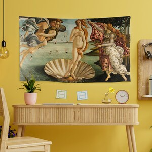 May include: A tapestry depicting a Renaissance-era painting of the birth of Venus. The painting shows a nude woman standing on a giant scallop shell, with two figures flanking her. The woman is surrounded by water and flowers.