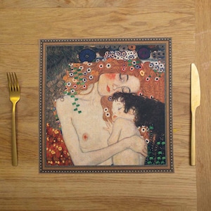 May include: A table placemat featuring a painting of a mother and child. The mother is lying down with her eyes closed, and the child is nestled in her arms. The painting is surrounded by a decorative frame.