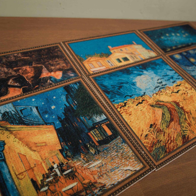 May include: A set of six framed coasters featuring famous paintings by Vincent van Gogh. The coasters are made of a woven fabric with a textured surface. The paintings include "Starry Night", "The Cafe Terrace at Night", "Wheatfield with Crows", and "The Yellow House".