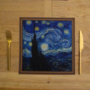 May include: A brown framed table mat with a printed image of Vincent van Gogh's "Starry Night" painting. The painting features a swirling blue sky with yellow stars and a dark cypress tree in the foreground.
