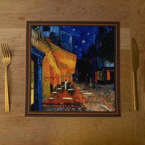 May include: A square, framed print of a painting depicting a cafe at night. The painting is in a style reminiscent of Vincent van Gogh, with swirling brushstrokes and a starry sky. The cafe is lit with warm yellow light, and there are people sitting at tables outside.