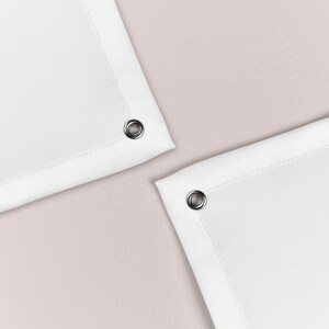 May include: Two white fabric shower curtains with silver grommets at the top corners.