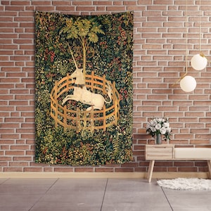 May include: A tapestry featuring a white unicorn trapped in a circular fence, surrounded by a lush green forest with colorful flowers and foliage.