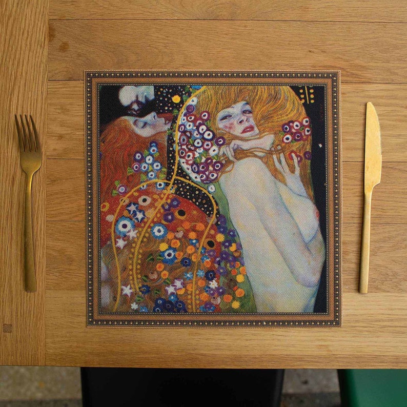 May include: A framed print of a painting depicting two women with a floral background. The painting is in a gold frame with a brown mat.