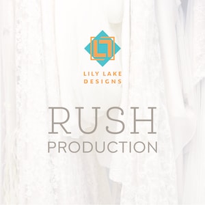 May include: White fabric backdrop with a teal blue and orange logo that says "Lily Lake Designs" and the text "Rush Production" in gray.