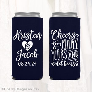 May include: Two navy blue can coolers with white text. One cooler says "Kristen & Jacob 08.24.24". The other cooler says "Cheers to many years and cold beers".