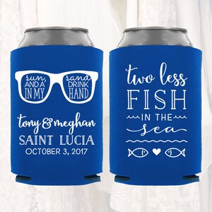 May include: Two blue and white can coolers. One cooler has the text "sun, and a in my sand drink hand" with a pair of sunglasses. The other cooler has the text "two less fish in the sea" with two fish and a heart.