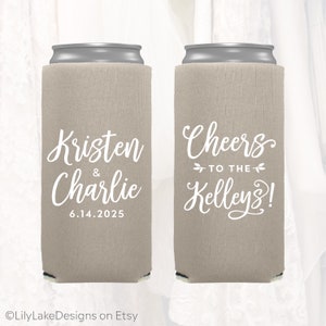 May include: Two beige can coolers with white text. One cooler says "Kristen & Charlie 6.14.2025". The other cooler says "Cheers to the Kelleys!"