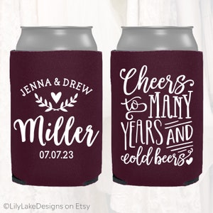 May include: Two maroon can coolers with white text. One cooler says "Jenna & Drew Miller 07.07.23". The other cooler says "Cheers to many years and cold beers".