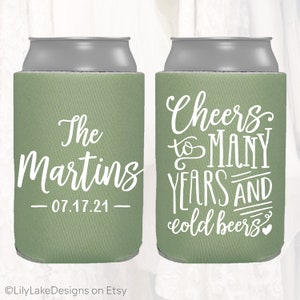 May include: Two green and grey can coolers. One cooler says "The Martins - 07.17.21" and the other cooler says "Cheers to many years and cold beers".