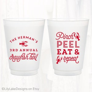May include: Two white plastic cups with red text and a crawfish design. The left cup says "The Herman's 3rd Annual crawfish boil". The right cup says "Pinch Peel Eat & repeat".
