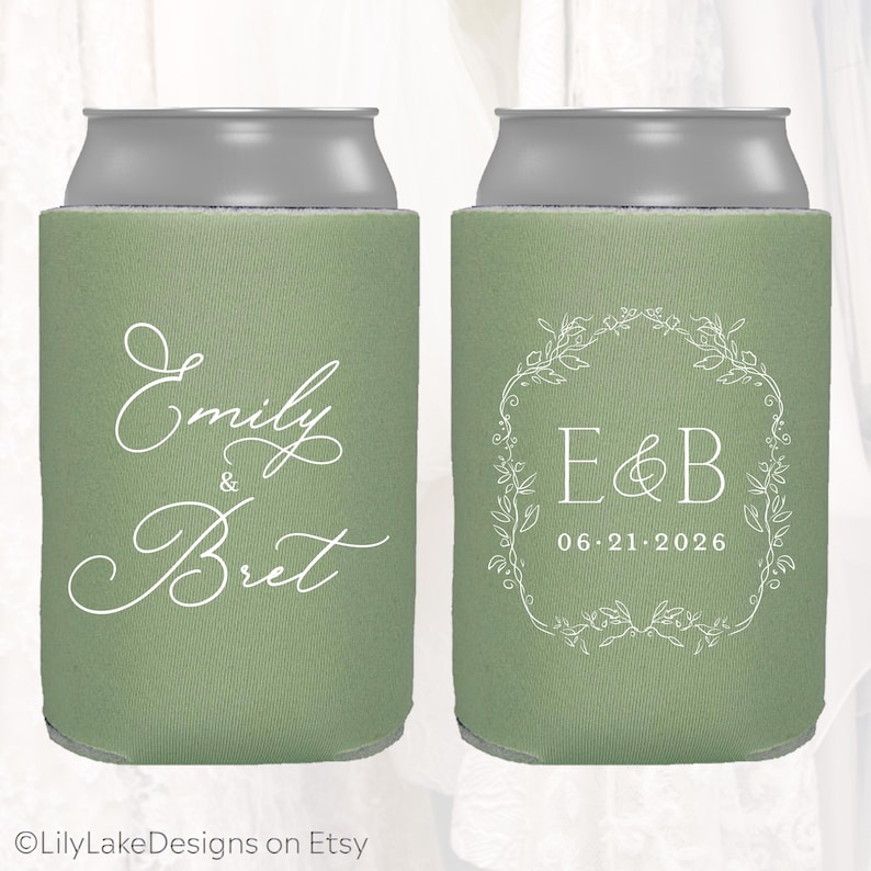 May include: Two green can coolers with silver tops. One cooler has the names "Emily & Bret" in white script. The other has "E&B" inside a floral wreath and the date "06.21.2026".