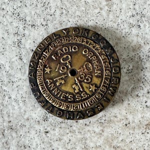 May include: A set of three ceramic mugs with a speckled, matte finish. The mugs are in shades of cream, light gray, and dark gray. Each mug has a simple, modern design and a rounded handle.