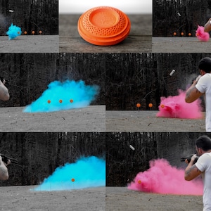 May include: A person shooting a shotgun at clay targets. The targets are exploding in a cloud of blue and pink smoke.