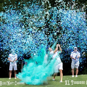 May include: A group of people are standing on a golf course, holding blue and white confetti cannons. One person is swinging a golf club, releasing a cloud of blue and green confetti. The text "24" Mint/Blue/Navy Cannons" is visible in the bottom left corner of the image. The text "XL Turquoise Golf Ball" is visible in the bottom right corner of the image.