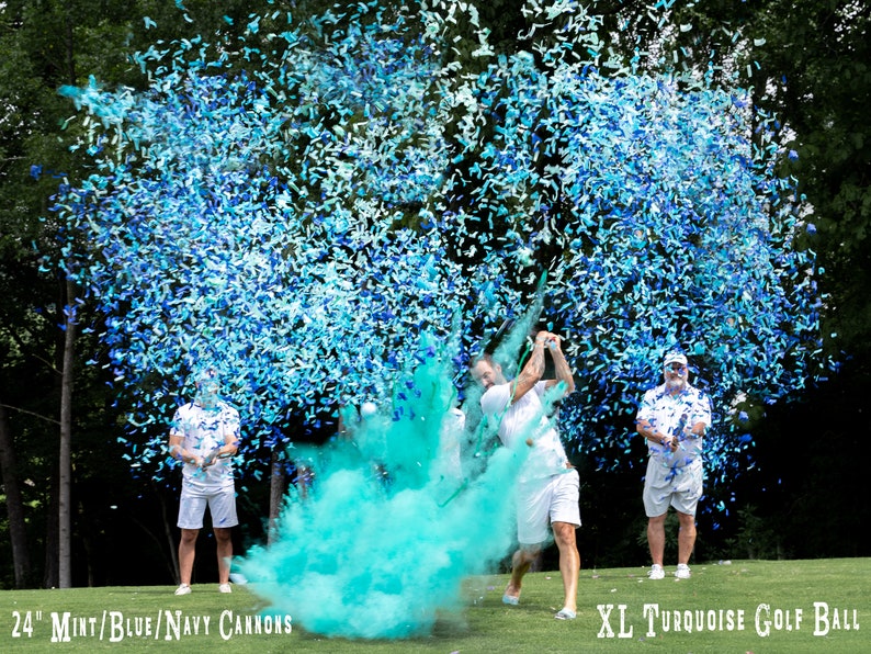 May include: A group of people are standing on a golf course, holding blue and white confetti cannons. One person is swinging a golf club, releasing a cloud of blue and green confetti. The text "24" Mint/Blue/Navy Cannons" is visible in the bottom left corner of the image. The text "XL Turquoise Golf Ball" is visible in the bottom right corner of the image.