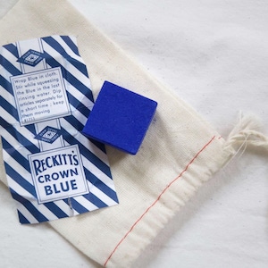 May include: A small blue fabric block labeled "Reckitt's Crown Blue" in a white cloth bag. The label includes instructions for using the blue fabric block to dye items.