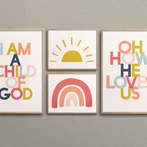 May include: Set of four framed prints with colorful text and illustrations. The prints feature the phrases "I am a child of God", "Oh how he loves us", and a rainbow and sun illustration.