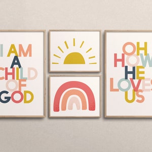 May include: Set of four framed prints with colorful text and illustrations. The prints feature the phrases "I am a child of God", "Oh how he loves us", and a rainbow and sun illustration.