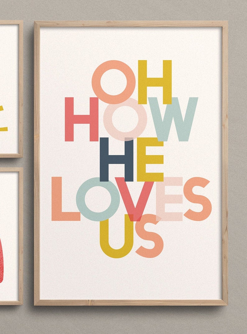 May include: A framed print with the words "Oh How He Loves Us" in a colorful, layered font design. The letters are in shades of pink, red, yellow, blue, and green.