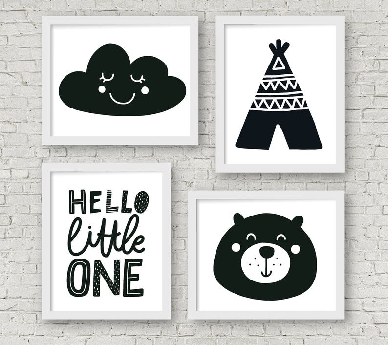 May include: Four black and white nursery prints with white frames. The prints feature a cloud with a smiling face, a teepee, the text "HELLO little ONE", and a bear face.