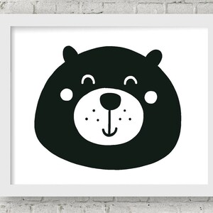 May include: Black and white illustration of a bear's face with a smiling expression. The bear has a round head, small eyes, and a large, round nose.