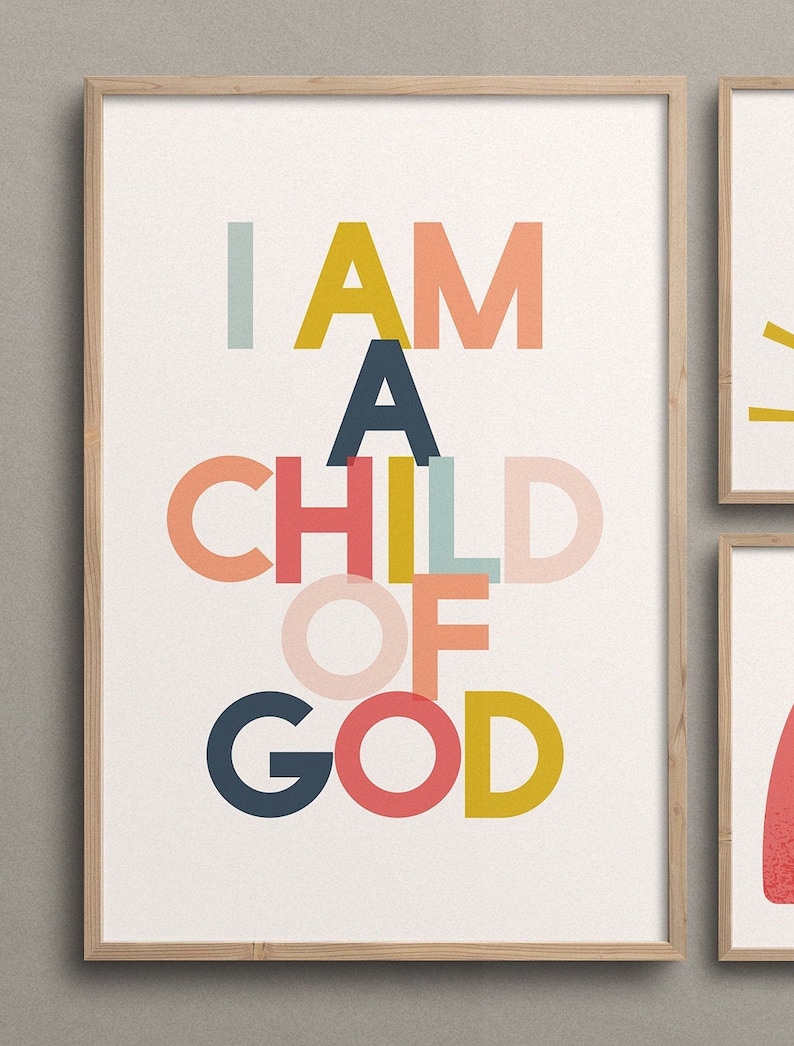 May include: A framed print with the text "I AM A CHILD OF GOD" in colorful, overlapping letters. The letters are in shades of pink, red, yellow, blue, and green.
