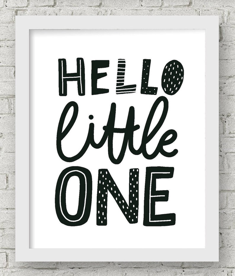 May include: Black and white printable wall art with the text "Hello little one" in a playful, hand-drawn style.