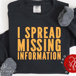 May include: Black sweatshirt with the text "I spread missing information" in orange letters.