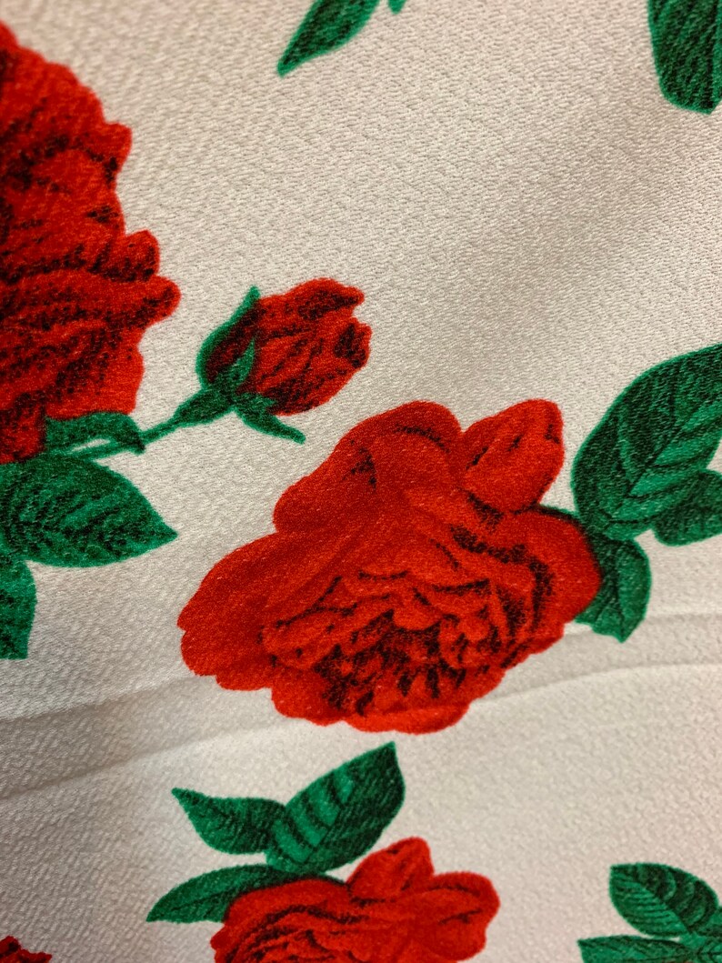 White 4 way stretch poly liverpool fabric with red all over  roses green leaves design sold by the yard