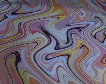 May include: Abstract fabric with a marbled design. The pattern features flowing, swirling lines in shades of pink, orange, yellow, blue, and black. The fabric has a textured appearance, suggesting a woven material.