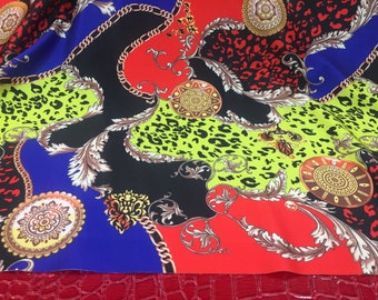 May include: A colorful fabric with a repeating pattern of chains, leopard print, and ornate designs in shades of red, black, green, gold, and blue.