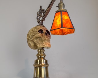 Carved skull accent lamp on vintage heavy brass base and mica shade.