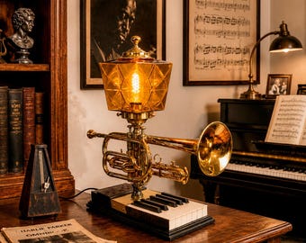 Vintage cornet accent lamp on vintage piano keys..