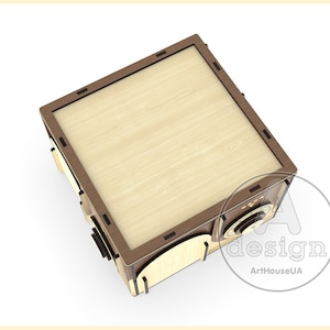 Op de afbeelding: Een houten doos met een bruine en lichte houtkleur. De doos heeft een decoratief ontwerp aan de voorkant en een knop aan de zijkant. De doos is gesloten en de bovenkant is zichtbaar.