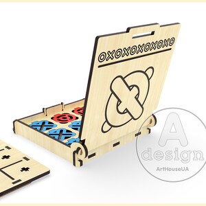 May include: Wooden tic-tac-toe game with a hinged lid that opens to reveal the game pieces. The lid has the text "OXOOXOOXOOXOO" printed on it. The game pieces are red and blue circles and blue and red crosses.