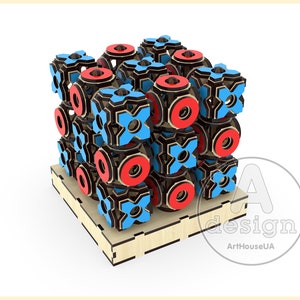 May include: A wooden 3D puzzle with a geometric design. The puzzle is made up of interlocking pieces that form a cube. The cube is decorated with red and blue circles and crosses.