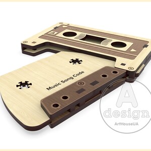 May include: A wooden cassette tape design with the text "Music Song Code" on the front. The cassette is made of two pieces of wood, one brown and one light wood.
