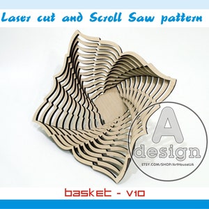 May include: A wooden basket with a layered design, created using laser cutting and scroll saw techniques. The basket is made of light-coloured wood and has a square shape with curved edges. The design includes the text "Laser cut and Scroll Saw pattern" and "basket - V10".