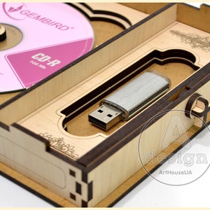 May include: A wooden box with a hinged lid, containing a silver USB flash drive and a CD-R labeled "GEMBIRD CD-R 700 Mb". The box has a decorative design with an "A design ArtHouseUA" logo.