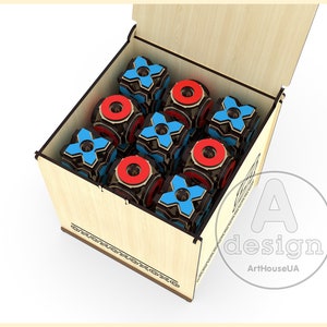 May include: A wooden box with a hinged lid, open to reveal a set of nine wooden cubes. The cubes are painted with red circles and blue crosses, resembling a tic-tac-toe game. The box is decorated with a simple design around the edges.