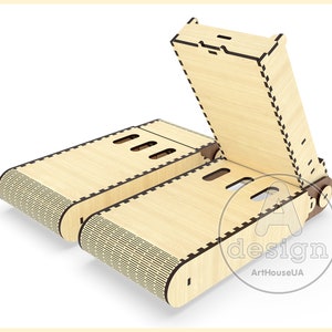 May include: A wooden phone stand with a folding design. The stand is made of light wood and has a patterned design on the bottom. The stand is open and ready to hold a phone.