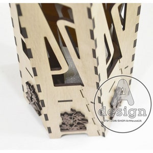 May include: A wooden box with intricate cutouts and a design of a tree. The box is made of light wood and has a dark brown stain. The box is open and the inside is visible. The box is labeled with the text "A design ETSY.COM/SHOP/ArtHouseUA".