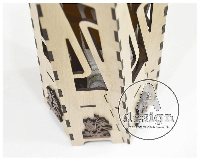 May include: A wooden box with intricate cutouts and a design of a tree. The box is made of light wood and has a dark brown stain. The box is open and the inside is visible. The box is labeled with the text "A design ETSY.COM/SHOP/ArtHouseUA".