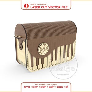 May include: A digital download laser cut vector file for a wooden box shaped like a piano. The box features a curved lid with a slatted texture, a front panel with a piano key pattern, and a circular emblem with a treble clef symbol.