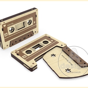 May include: A wooden cassette tape with a brown and beige wood grain pattern. The cassette tape is open and the tape is visible. The cassette tape has the text "Music Song Code design ArtHouseUA" on the side.