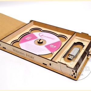 May include: A wooden box with a CD-R disc and a USB drive inside. The box is open and the CD-R disc is visible. The box is labeled "Wedding Story".
