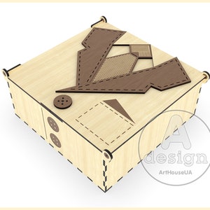May include: A wooden box with a decorative design of a suit and tie on the lid. The box is made of light wood with brown accents. The box is closed and sitting on a white surface.