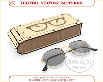 Puede incluir: Un estuche de gafas de madera con un diseño de gafas cortado con láser y el texto "Glasses case". El estuche está abierto y un par de gafas de sol de montura dorada con lentes grises está sentado junto a él.